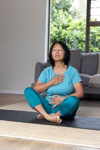 Senior woman practicing mindful breathing at home