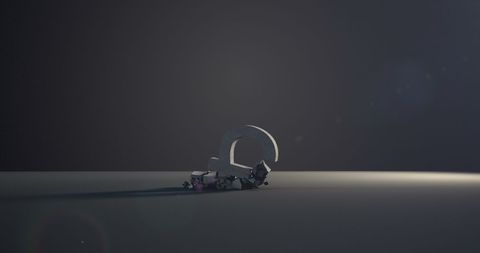 Breaking pound currency symbol amidst shattered pieces