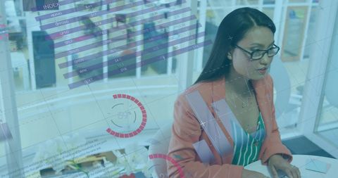 Businesswoman analyzing financial data on transparent display