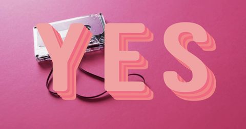 Retro cassette tape with yes text on pink background