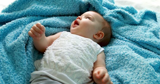 Cute baby girl lying on bed in bedroom - Download Free Stock Photos Pikwizard.com