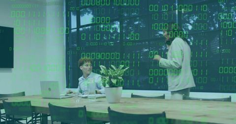 Business team collaborating with green binary code overlay in modern conference room