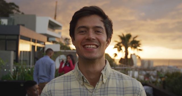 Man Smiling at Sunset Outdoor Gathering - Download Free Stock Images Pikwizard.com