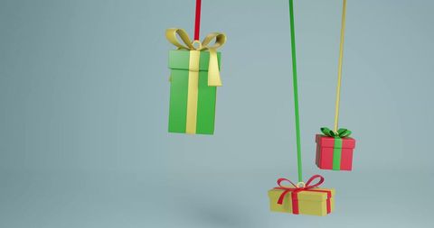Colorful hanging gift boxes on plain background