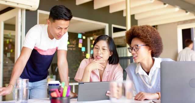 Diverse Group of Young Professionals Collaborating on Tablet - Download Free Stock Images Pikwizard.com