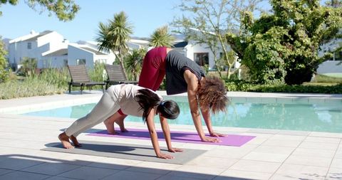 Mother and Daughter Embracing Yoga by Poolside in Sunny Garden