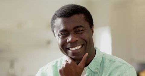 Smiling African American Man Relaxing in Bright Kitchen