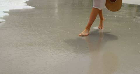 Tranquil Beach Walk with Sea Foam Touching Feet