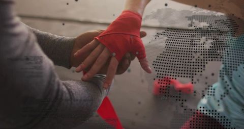 Coach adjusting red hand wrap during boxing training close-up with halftone overlay