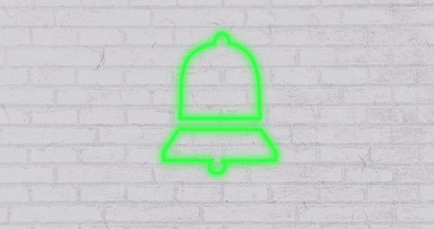 Neon green bell icon glowing on white brick wall