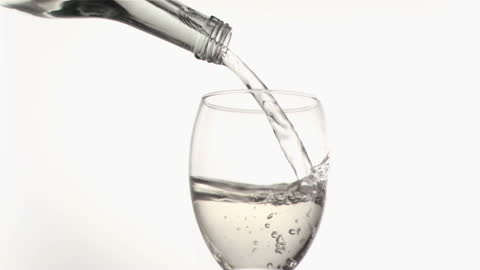 White Wine Splashes from Bottle to Glass