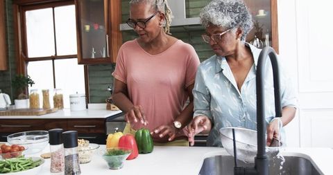 Senior Women Friends Cooking Together in Modern Kitchen