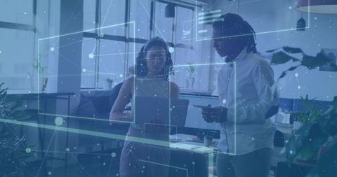 Experts analyzing futuristic holographic interface in modern workspace