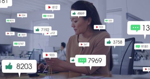 Asian Businesswoman Engaged with Social Media Analytics in Modern Office