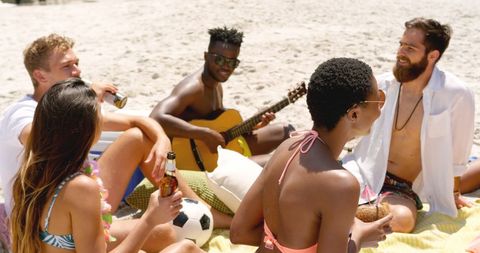 Diverse Friends Enjoying Beach with Guitar Music