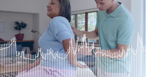 Caregiver supporting senior woman on sofa at home with digital health waveform overlay