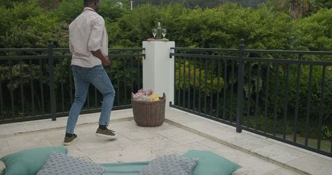 Man Preparing Patio for Outdoor Wedding Reception
