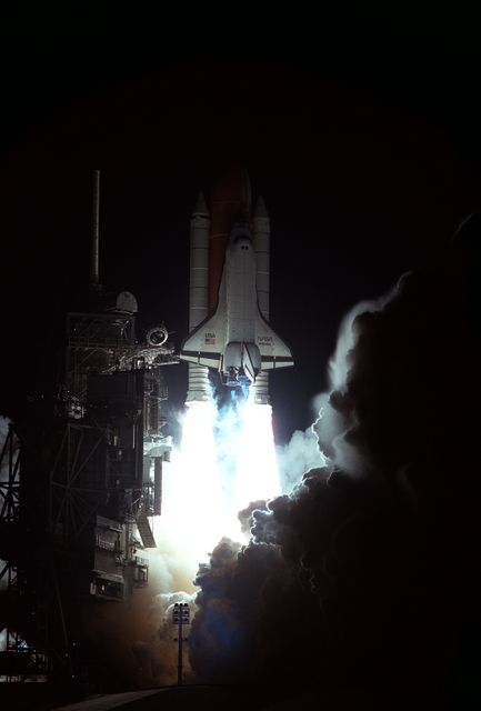 Nighttime view of Space Shuttle Atlantis launching from Kennedy Space Center's Launch Pad 39B on March 22, 1996, towards Earth orbit. The mission aimed to dock with Russia's Mir Space Station. The launch highlights the intensity and power of space travel. Great for use in articles and presentations discussing space exploration, historical space missions, or NASA's work.