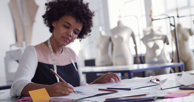 African American Female Fashion Designer Sketching in Studio - Download Free Stock Images Pikwizard.com