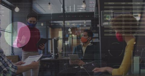 Diverse team analyzing data on digital interface in modern office