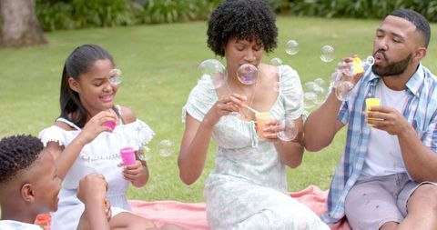 Family Blowing Bubbles Outdoors Having Fun Together - Download Free Stock Images Pikwizard.com