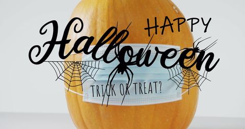 Pumpkin with face mask & halloween greeting text overlay