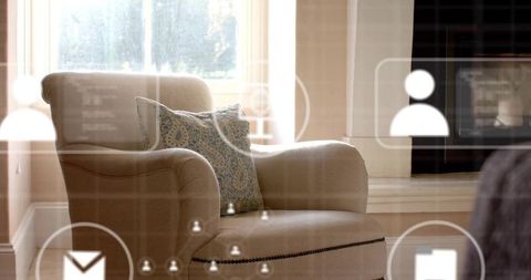Cozy beige armchair featuring nailhead trim and patterned pillow with translucent ui overlay