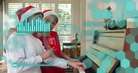 Mature women wearing santa hats embracing at piano with augmented reality holiday hud