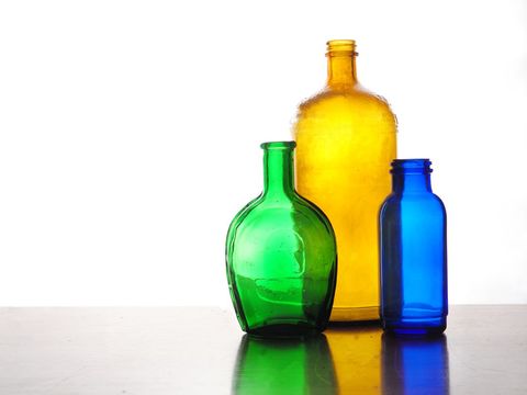 Colorful Vintage Glass Bottles on Reflective Surface