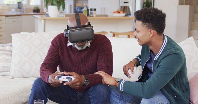 Elderly Man Using VR Headset with Assistance of Younger Man on Couch - Download Free Stock Images Pikwizard.com