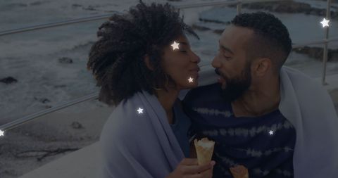 Romantic african american couple eating ice cream by the beach