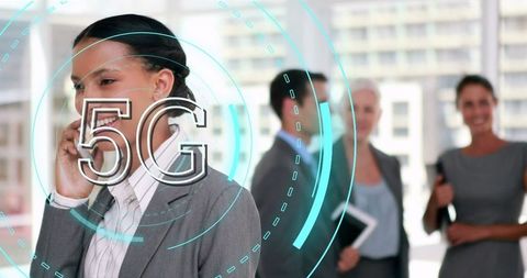 Businesswoman using 5g smartphone technology in corporate office