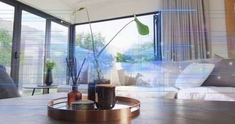 Minimalist living room with copper tray, mug and plant on coffee table in sunlit interior