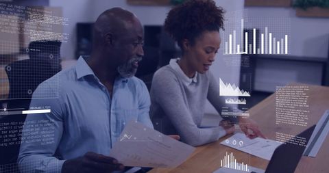 Diverse colleagues analyzing data with digital interface elements