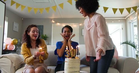 Joyful Birthday Celebration with Friends in Cosy Sunlit Living Room