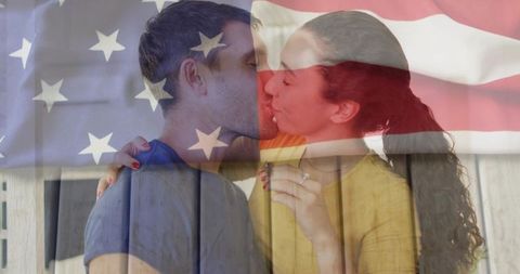 Romantic kiss of engaged couple with american flag overlay