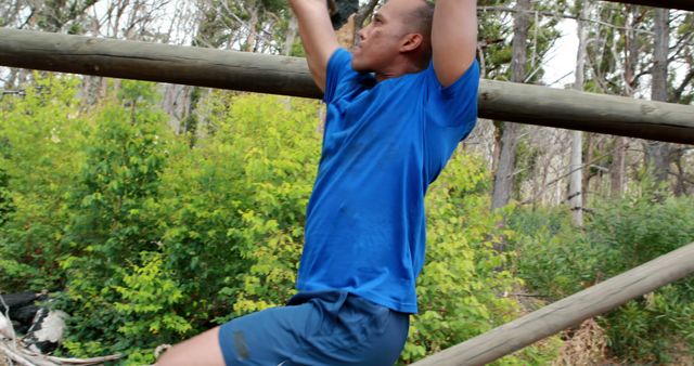 Man in Blue Shirt Exercising on Outdoor Monkey Bars - Download Free Stock Images Pikwizard.com