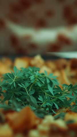 Chef arranging fresh herbs on cutting board with diced vegetables vertical cooking clip