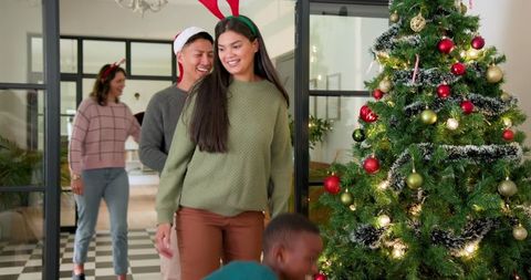 Diverse Family Celebrating Christmas Around Decorated Tree
