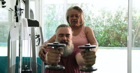 Senior Couple Enjoying Home Workout with Dumbbells