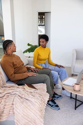 Diverse Friends Collaborating on Laptop in Modern Living Room