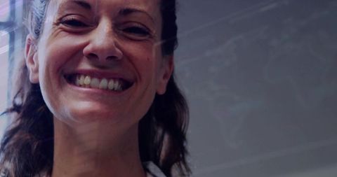 Businesswoman Smiling While Presenting Data on Glass Board in Office
