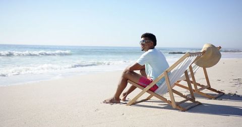Relaxed man enjoying serene beach views in tranquil setting