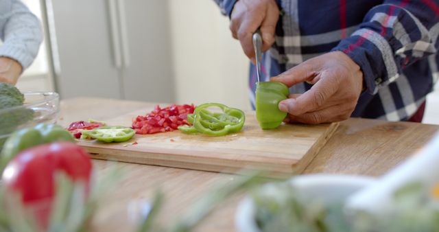 Person chopping green bell pepper on kitchen counter - Download Free Stock Images Pikwizard.com