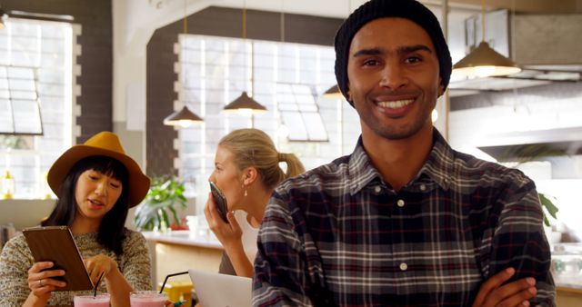 Smiling Young Man With Friends in Modern Coffee Shop - Download Free Stock Images Pikwizard.com