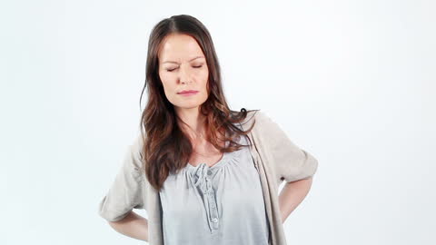 Woman Experiencing Back Pain on Isolated Background