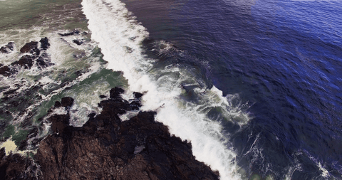 transparent waves crashing onto rocky shoreline from above - Download Free Stock Videos Pikwizard.com