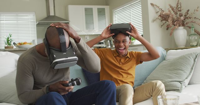 Father and Son Enjoying Virtual Reality Gaming on Couch at Home - Download Free Stock Images Pikwizard.com