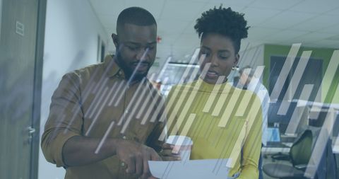 Diverse Team Analyzing Financial Data with Digital Interface in Office