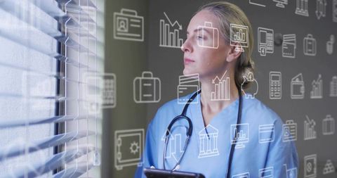 Clinician holding tablet analyzing healthcare data through blinds with stethoscope